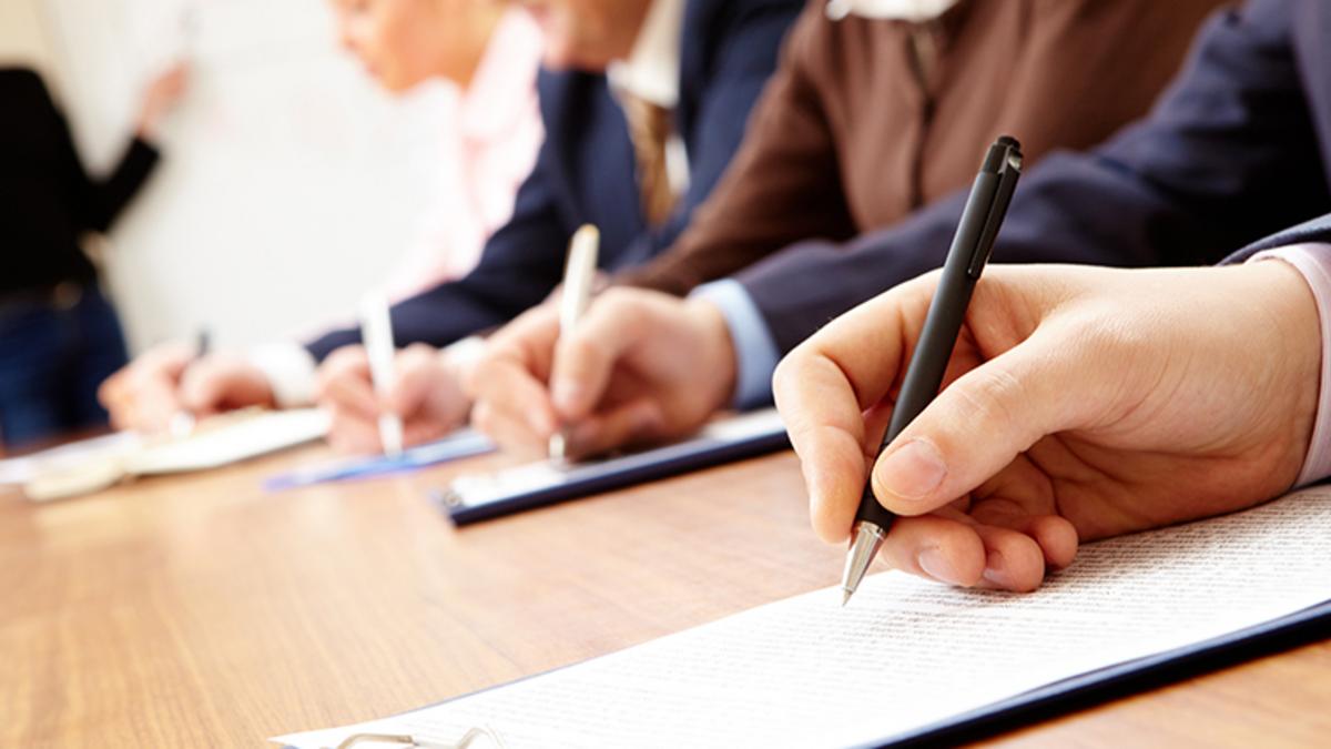 generic image of hands signing docs