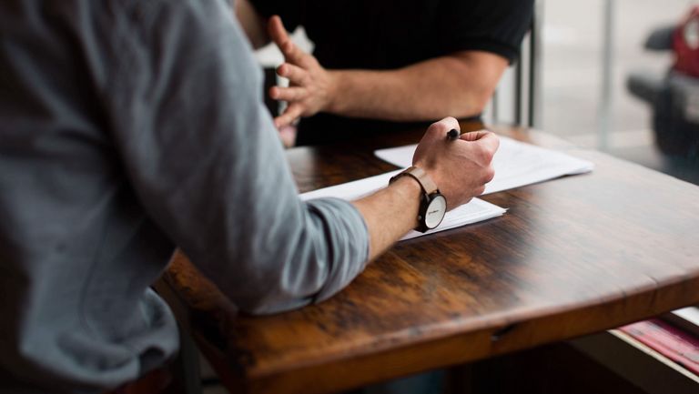 People writing on a paper