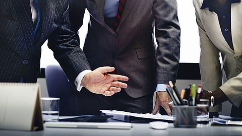 Businessman talking around a desk